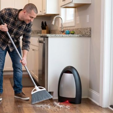 Man using touchless vacuum dustpan.