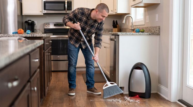 Man using touchless vacuum dustpan.